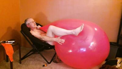 Perverted stepdad is playing with huge pinky balloon in the bedroom