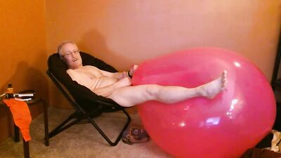 Perverted stepdad is playing with huge pinky balloon in the bedroom
