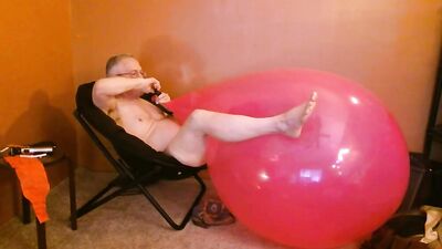Perverted stepdad is playing with huge pinky balloon in the bedroom