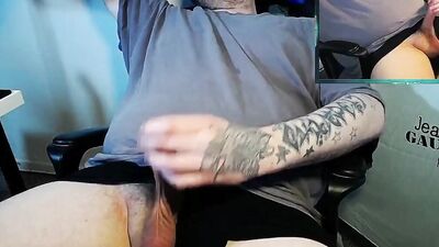 Tattooed bloke is filming himself while playing with a pecker