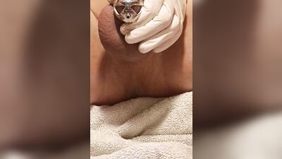 Perverted gay chap plays with his pecker with a gloves on