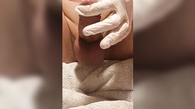 Perverted gay chap plays with his pecker with a gloves on