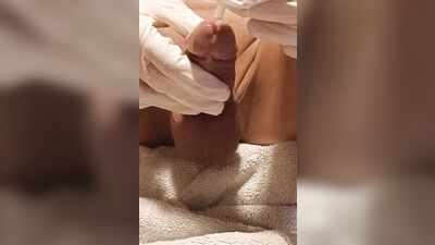Perverted gay chap plays with his pecker with a gloves on