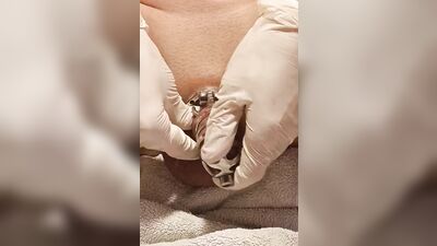 Perverted gay chap plays with his pecker with a gloves on