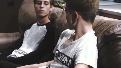 Skinny gay chap is riding his lover's hard cock on the couch