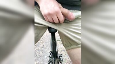 Naughty gay chap is flashing his pecker while riding a bike
