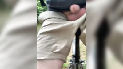 Naughty gay chap is flashing his pecker while riding a bike