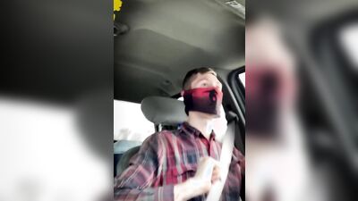 Amateur masked bloke is having fun while driving a car