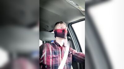 Amateur masked bloke is having fun while driving a car