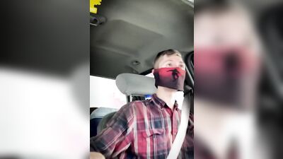 Amateur masked bloke is having fun while driving a car