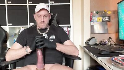 Perverted gay chap is stroking his hard schlong with gloves