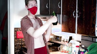 Masked teen enjoys in his solo performance inside the kitchen
