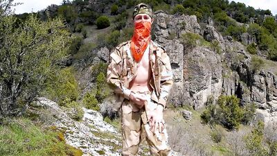 Skinny masked chap is playing with a dick on top of the mountain