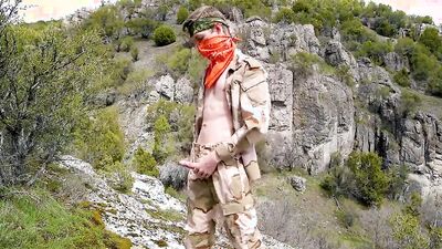 Skinny masked chap is playing with a dick on top of the mountain