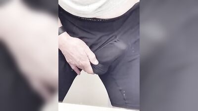 Perverted fellow is playing with a penis inside the public bathroom