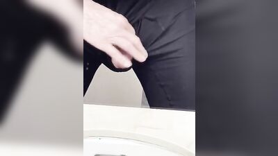 Perverted fellow is playing with a penis inside the public bathroom
