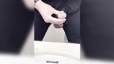 Perverted fellow is playing with a penis inside the public bathroom