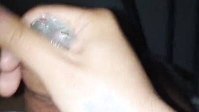 Amateur bloke is jerking his prick with a condom on
