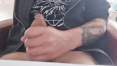 Tattooed fellow is jerking his dick in front of the phone