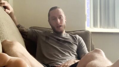 Carter Bennett is stroking his hard prick on the couch