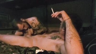 Lad gets his cock sucked hard while smoking a cigarette