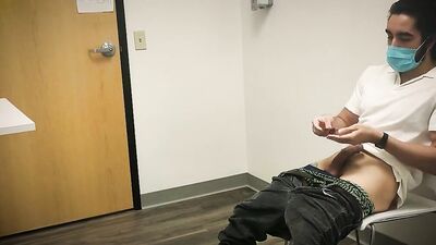 Bearded chap is stroking his hard prick inside the sperm bank