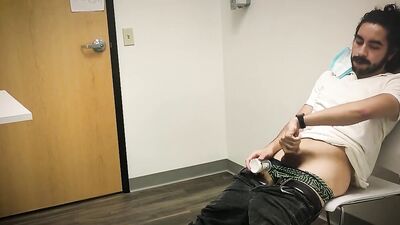 Bearded chap is stroking his hard prick inside the sperm bank