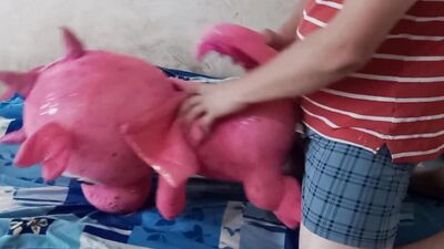 Perverted fellow is rubbing his hard willy on a cute pinky toy