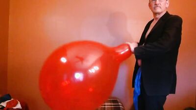 Perverted grandpa is playing with huge balloon in front of the cam