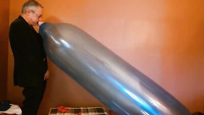 Perverted grandpa is playing with huge balloon in front of the cam