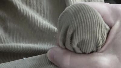 Close-up video of chap stroking his prick with a condom on