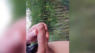 Amateur gay dude is stretching his big dick out in the open