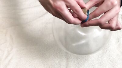 Lad plays with a condom in front of the camera