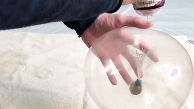 Lad plays with a condom in front of the camera
