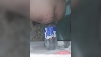 Amateur chap is riding a bottle in front of the camera