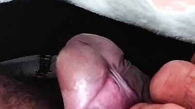 Close-up footage of a chap playing with his pecker