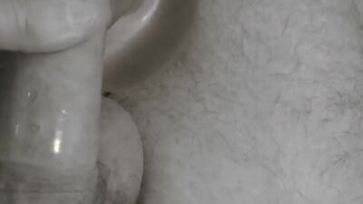 Amateur lad strokes his tiny pecker with a condom on