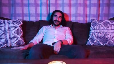 Longhaired mustache dude ia jerking his willy on the couch