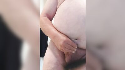 Amateur fatty is playing with a pecker in front of the camera