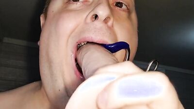 Chubby amateur bloke is wrapping his slimy mouth around huge dildo