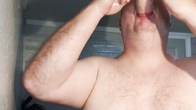 Cock hungry bloke is filling his slimy mouth with a huge dildo