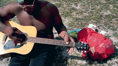 Amateur African chap is playing a guitar in front of the cam