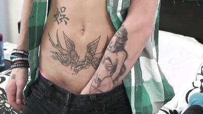 Blond tattooed chap is stroking his cock inside the bedroom