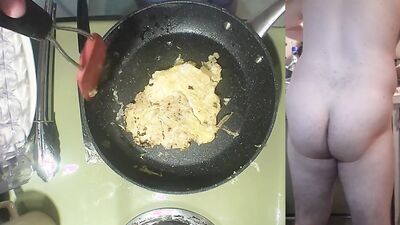 Perverted amater bloke is making a becon and eggs sandwich naked