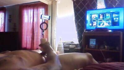 Amateur lad is rubbing his pecker on a bed while watching TV