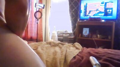 Amateur lad is rubbing his pecker on a bed while watching TV