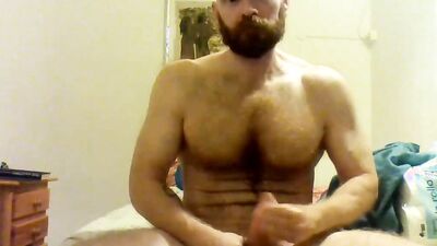 Beefed bearded bloke is masturbating in front of the cam