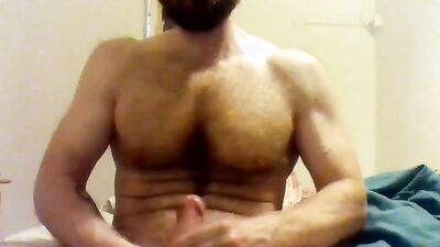Beefed bearded bloke is masturbating in front of the cam