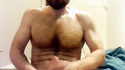 Beefed bearded bloke is masturbating in front of the cam