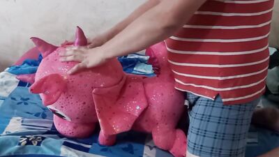 Lad rubs his hard wily on a cute pinky dinosaur